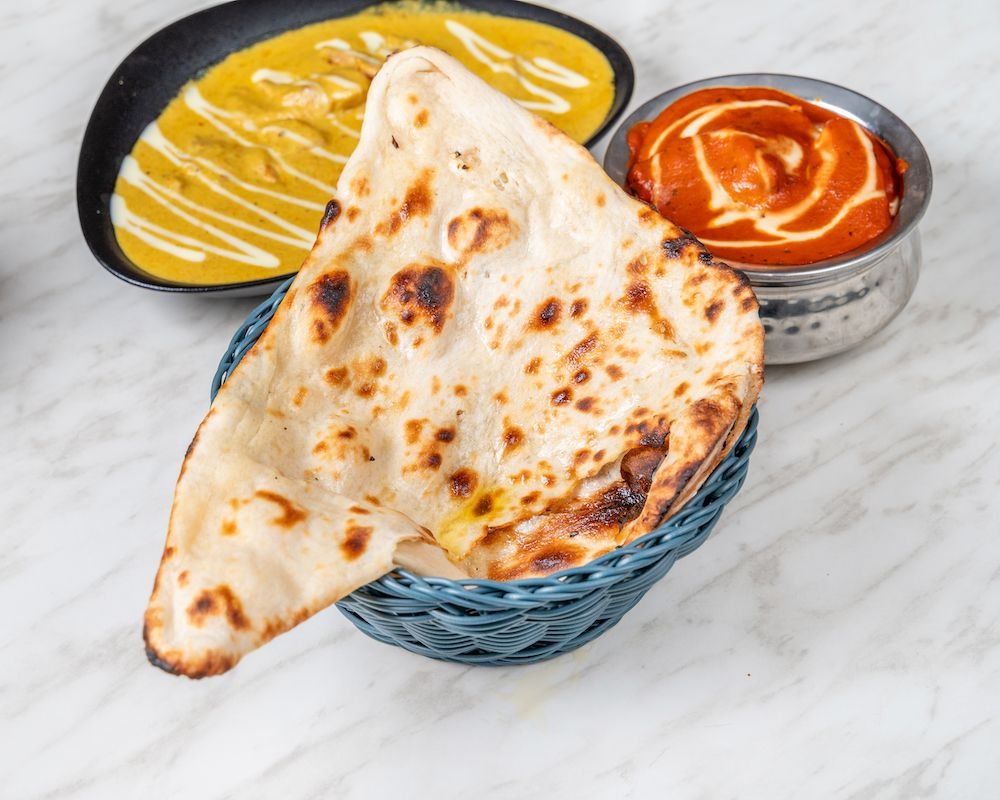 Naan from the tandoor with butter chicken and korma