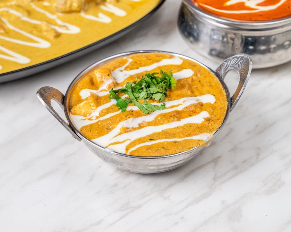 Paneer curry in a copper-handled kadai
